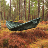 DD Hammocks Camping Hammock set up in a forest, showcasing its lightweight and durable design for outdoor adventures.